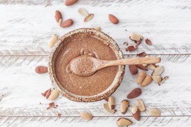 An overhead photo of a bowl of homemade almond butter filled with nutrients like calcium